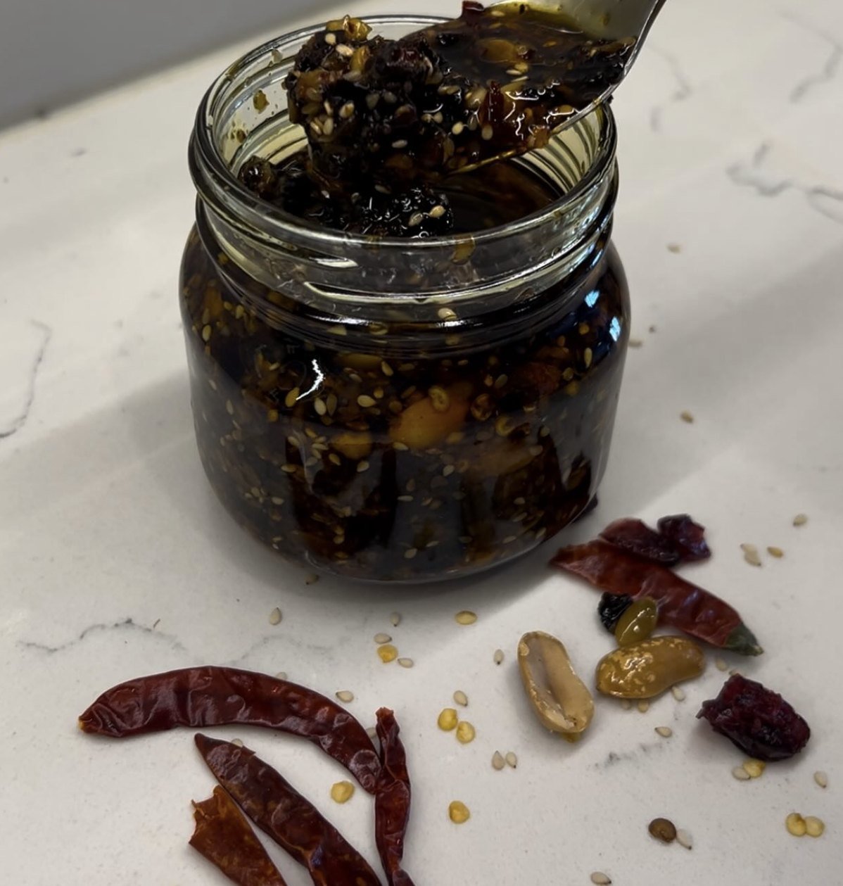 A jar of Totonaca salsa macha with sesame, peanuts, dried chiles and cranberries